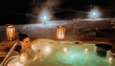 young woman enjoying outdoor bathtub in her terrace during cold winter evening.