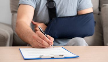 front view of a handicapped man with sling signing contract at home